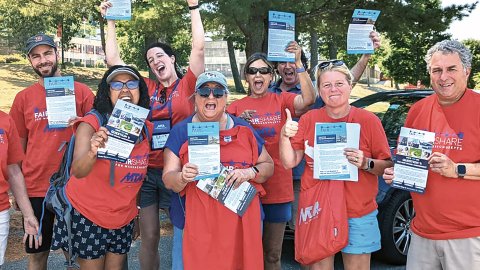 Massachusetts teachers wearing red shirts rally in support of the fair share amendment