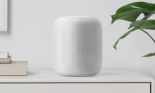 Apple HomePod sitting on a shelf.