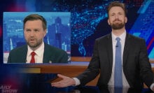 A man in a suit sits behind a talk show desk with his arms spread wide. In the top-left is an image of another man in a suit.