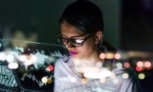 A female tech executive looking at a computer.