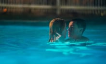 Nicole Kidman and Harris Dickinson are wrapped in each other's arms in a pool in the film "Babygirl."