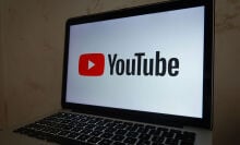 YouTube logo on laptop screen