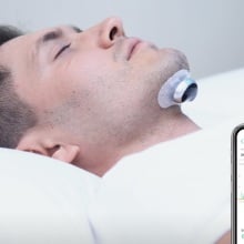 Person sleeping with the Snore Circle Electronic Muscle Stimulator.