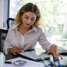 woman creating resume on tablet