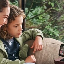 A mom and a child make a video call on an Echo Show 4