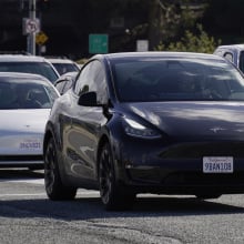 Tesla vehicles drive on the street on February 2, 2024 in San Bruno, California. 