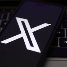 X logo on mobile device