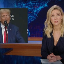 A woman sits behind a talk show desk. In the top left is an image of a man in a suit standing at a podium.