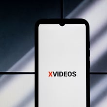 The XVideos logo is being displayed on a smartphone screen