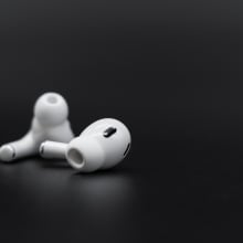 A pair of AirPods outside of their case. 