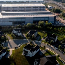 An aerial shot of an Amazon data center, right next to a residential neighborhood. 