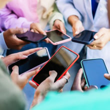 Teen friends watching social media content on smartphone app. 