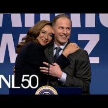 Maya Rudolph as Kamala Harris embracing Andy Samberg as Doug Emhoff at a podium in the 'SNL' cold open