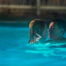 Nicole Kidman and Harris Dickinson are wrapped in each other's arms in a pool in the film "Babygirl."