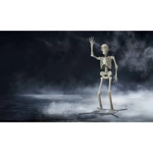 a giant, waving skeleton against a foggy background 