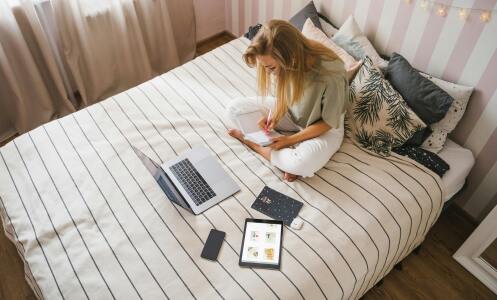 Girl with laptop on bed