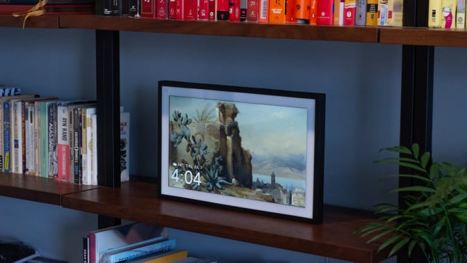 picture frame-esque smart screen on a bookshelf