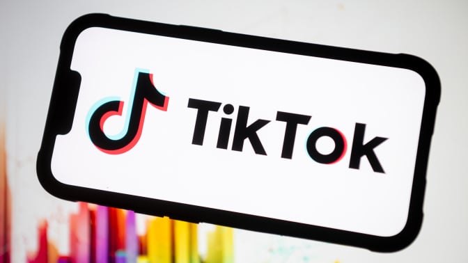 tiktok logo on a phone screen with colorful background