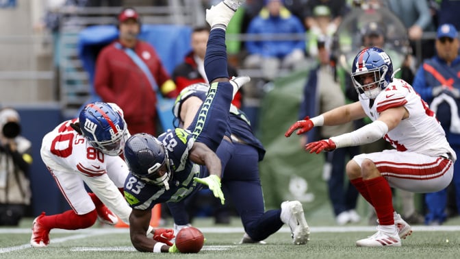 Dareke Young of the Seattle Seahawks grabs a fumble