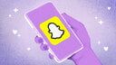 A drawn hand holding a phone with the Snapchat logo