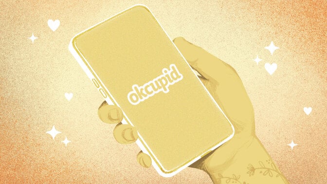 A drawn hand holding a phone with the okcupid logo