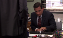 A man (Steve Carell as Michael Scott on "The Office") tuning up the volume on his computer.