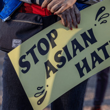 A yellow sign that reads 'Stop Asian Hate.'