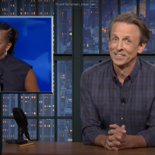 Seth Meyers presents "Late Night" beside a picture of Michelle Obama.