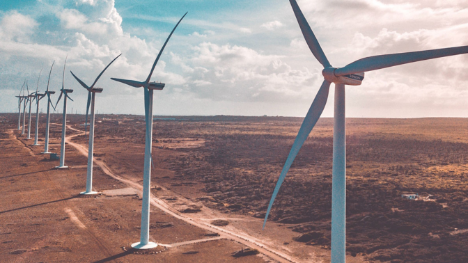 field of wind turbines with cloudy sky