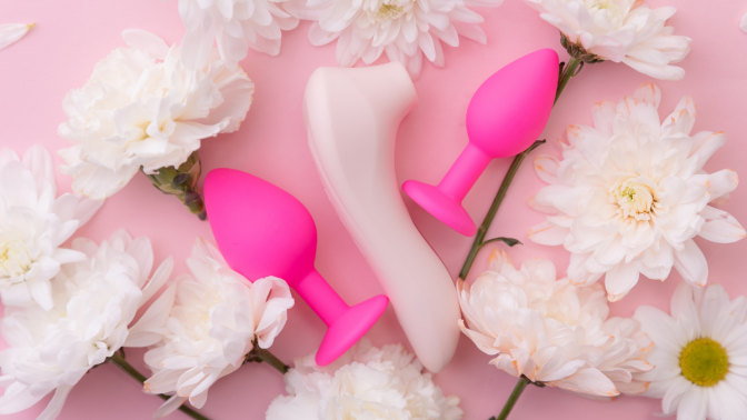 flat lay of sex toys with flowers 