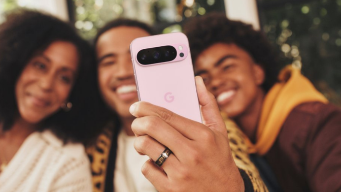 Three people taking a selfie on pink Google Pixel 9 Pro smartphone